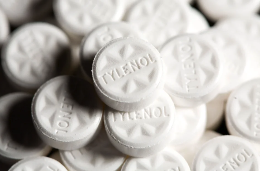 Close-up of a pile of white Tylenol pills.