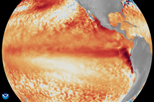 A satellite image of Earth centered over the Pacific Ocean; the water is shaded in gradients of light to deep orange and red.