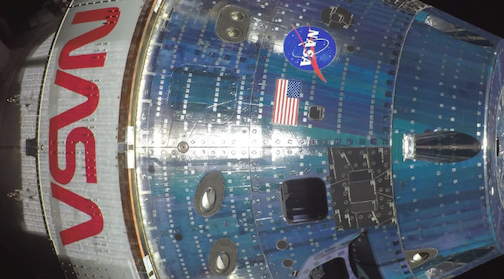 A close-up of the Orion capsule exterior including the NASA logo