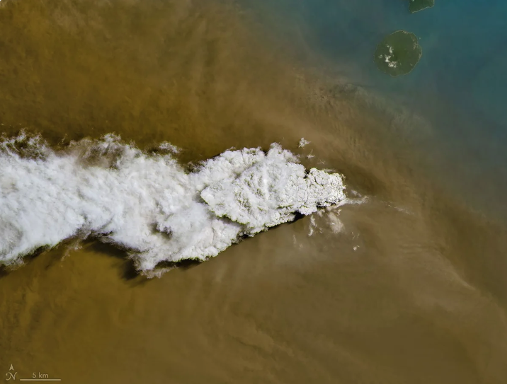 Satellite image of a giant plume of smoke emerging from the ocean