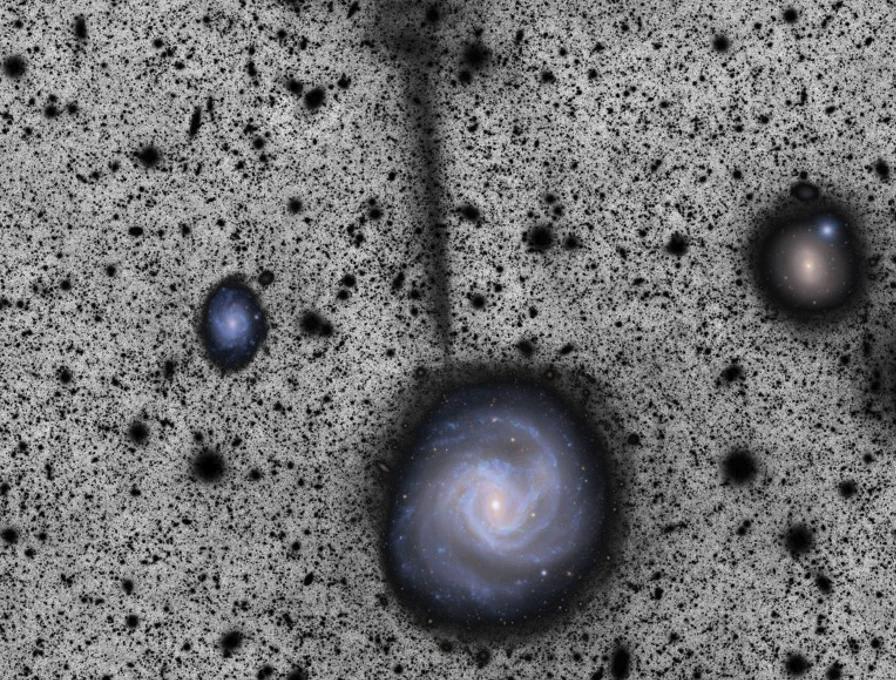 A composite image showing a spiral galaxy from above amid a black and white speckled space, with a black tail of material streaming off it.