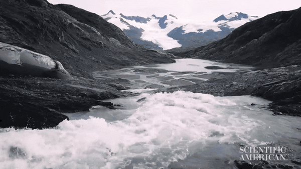 A GIF of water rushing with snowy mountains in the background.