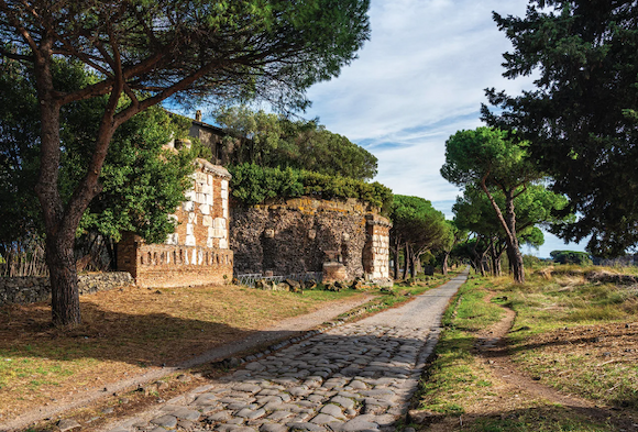 A stretch of the Via Appia showing the straight construction and stone paving associated with classic Roman roads