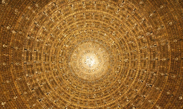 A circle of gold photomultiplier tubes that are part of the JUNO neutrino observatory.