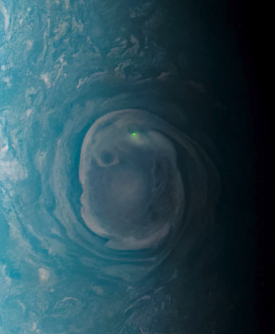 A small green dot within an oval storm indicates lightning on Jupiter