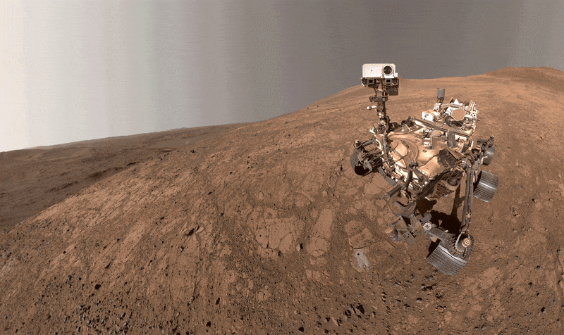 NASA's Perseverance rover swivels its head against an austere Martian backdrop.
