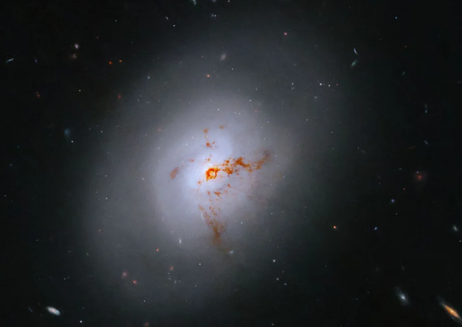 An image of a galaxy with a bright center and a face that hints at spiral structure, yet it holds no discernable spiral arms.