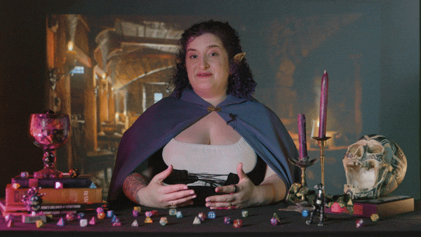 A GIF of Rachel Feltman, in elf costume, talking to Brennan Lee Mulligan
