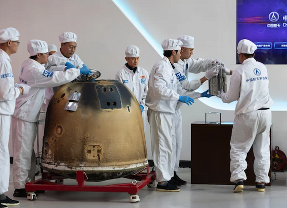 Researchers prepare to weigh Chang'e-6 lunar samples.