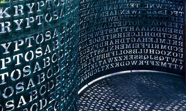A photo of a curving sculpture featuring encrypted code on its surface.