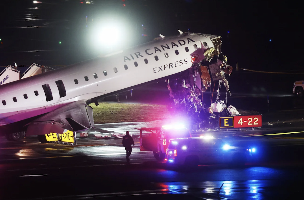 An Air Canada plane crashed at La Guardia airport surrounded by emergency services vehicles