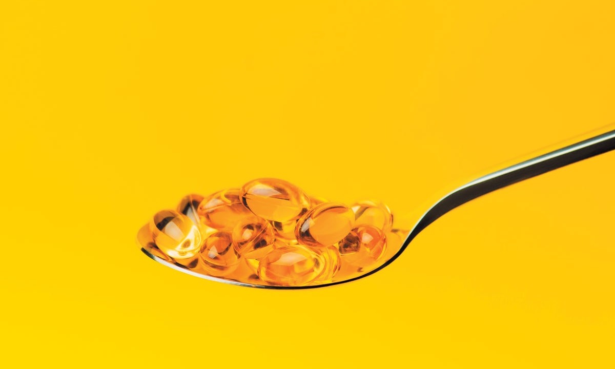 Capsules of omega-3 fatty acids on spoon