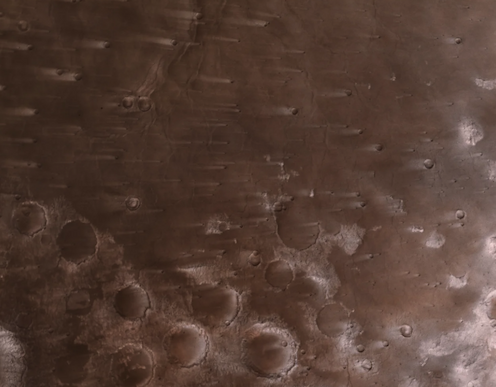 Brown and windswept craters on Mars's surface.