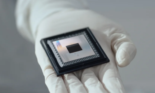 Image: Gloved hand holding Google's Willow quantum computer chip