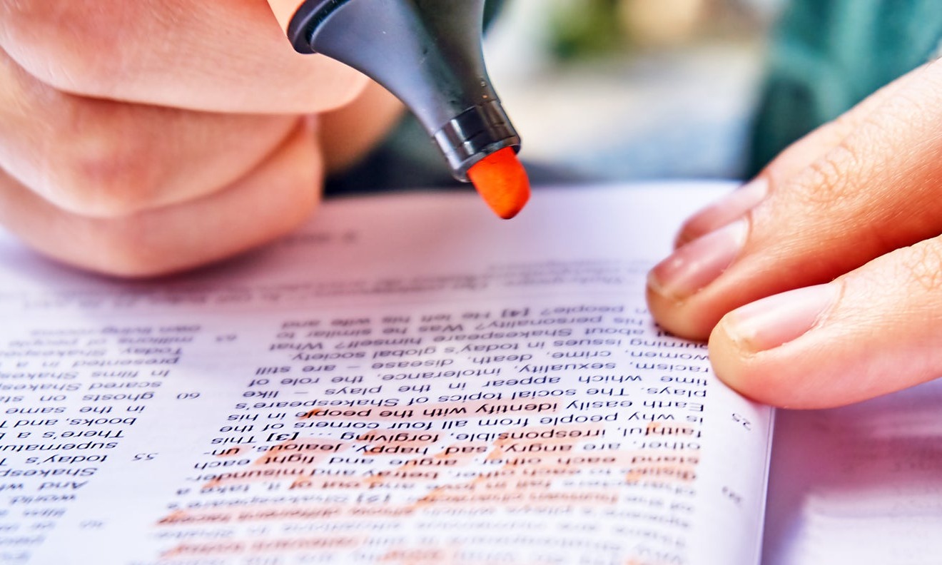 Person highlighting book