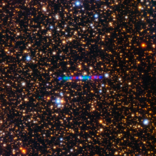 3I/ATLAS streaks across a dense star field in this image, composed of exposures taken through three filters, shown here as red, green and blue.