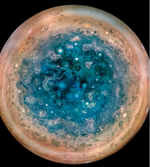 A centered view of Jupiter's southern pole, showing several round cyclones in the center.