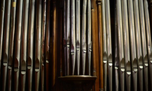 Close-up of the silver pipes on a vintage organ.