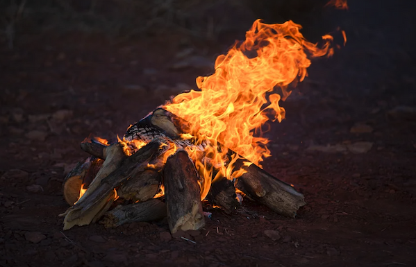 Logs burn in a small campfire