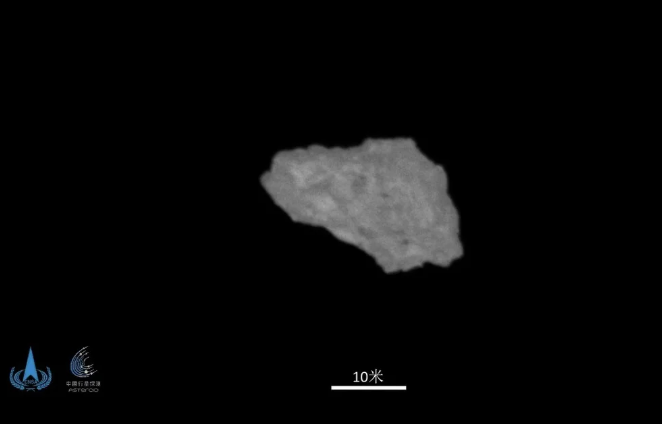 A blurry gray-looking rock in black space