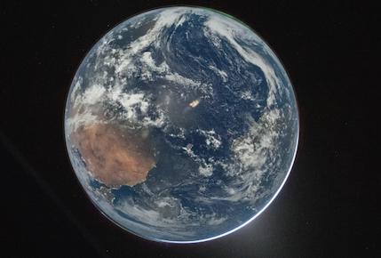 A view of Earth from space with auroras around its perimeter.