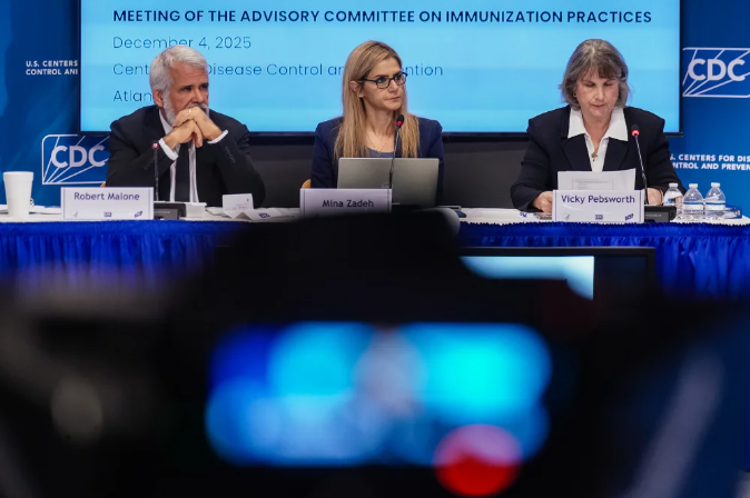 Photo of three people sitting at a table as part of a panel for vaccine policy at the CDC.