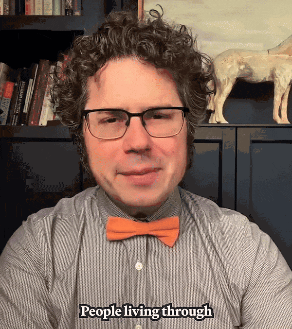 GIF of a man with glasses and a salmon-colored bowtie speaking directly to the camera.