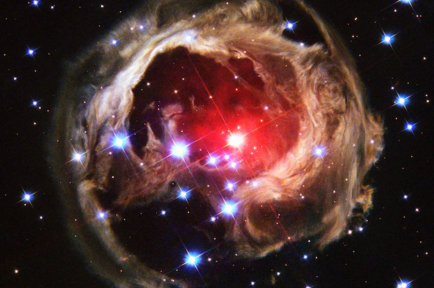 Hubble captured this view of an expanding halo of light around a distant star, named V838 Monocerotis (V838 Mon) on February 8, 2004. The illumination of interstellar dust comes from the red supergiant star at the middle of the image, which gave off a flashbulb-like pulse of light in 2002