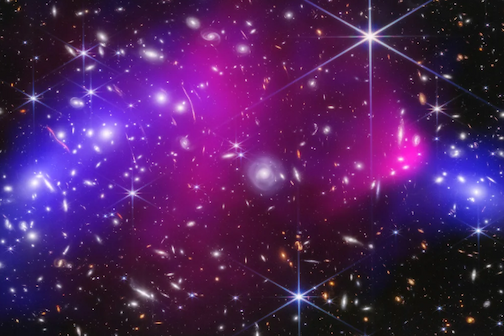 JWST near-infrared data combined with Chandra X-ray data of the Bullet Cluster show many overlapping objects, including foreground stars, galaxies in galaxy clusters, and distorted background galaxies behind the galaxy clusters, set against the black background of space. A large blue oval, two pink areas, and a smaller blue area are layered on top