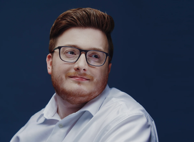 A portrait photograph of Colin Carlson, who looks off camera
