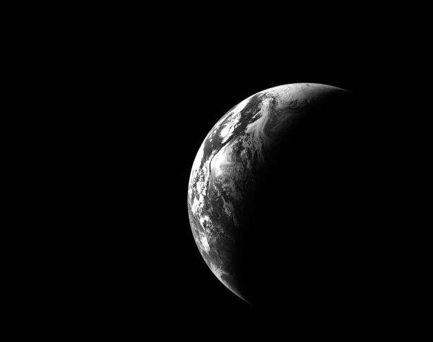A black and white view of a crescent Earth as seen from space.