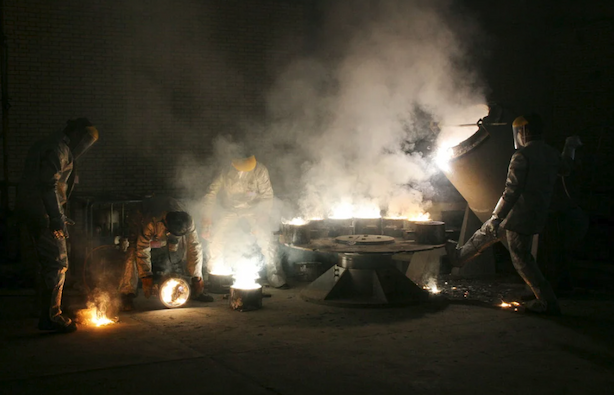 Men work inside of an uranium conversion facility just outside the city of Isfahan, Iran