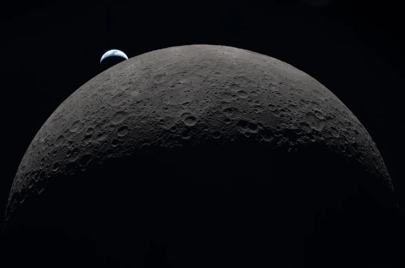 A crescent Earth sets over the far side of the moon