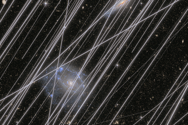 A simulated image representing the projected contamination by satellite trails that obscure galaxies and stars in the background.