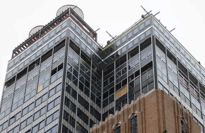 A Manhattan skyscraper under construction and showing signs of damage