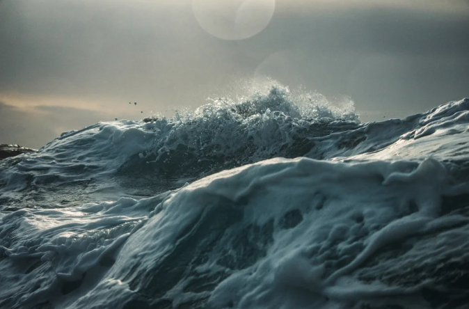 View of crashing waves with rough water on open ocean