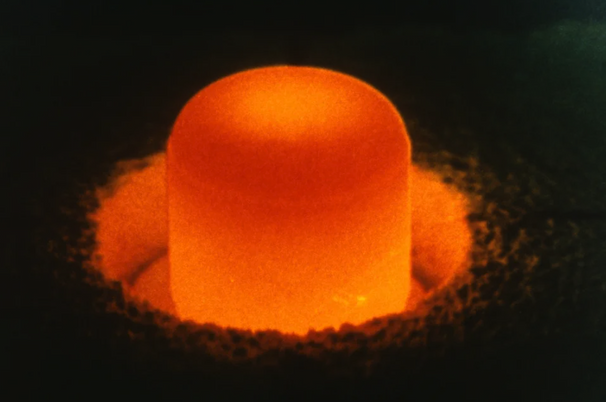 A pellet of plutonium-238, illuminated by the glow of its own radioactivity
