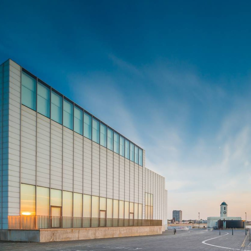 Exterior of the Turner Contemporary and Margate beach bathed in the warm glow of a sunset