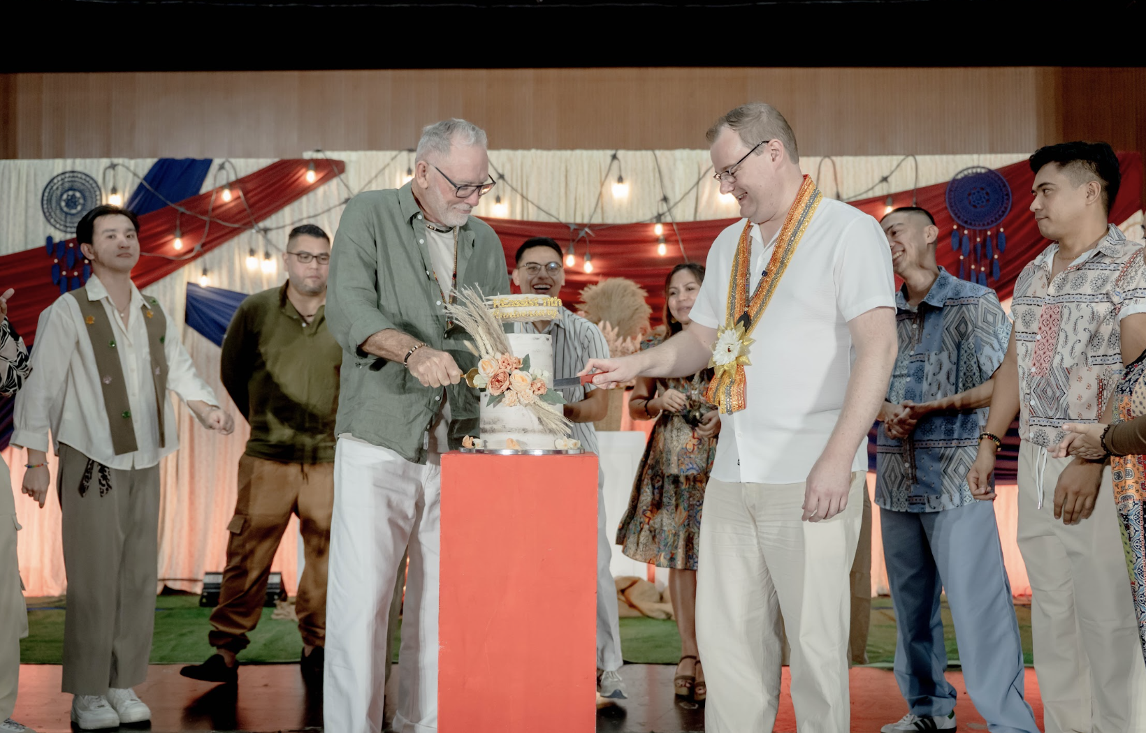 Ian and Andrew leading the ceremonial cake cutting at REassist 11th anniversary