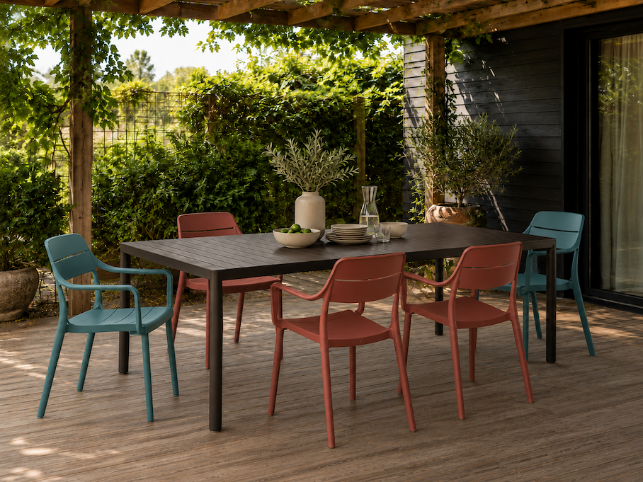 Nardi outdoor dining chairs in terracotta and sage arranged around an alfresco dining table