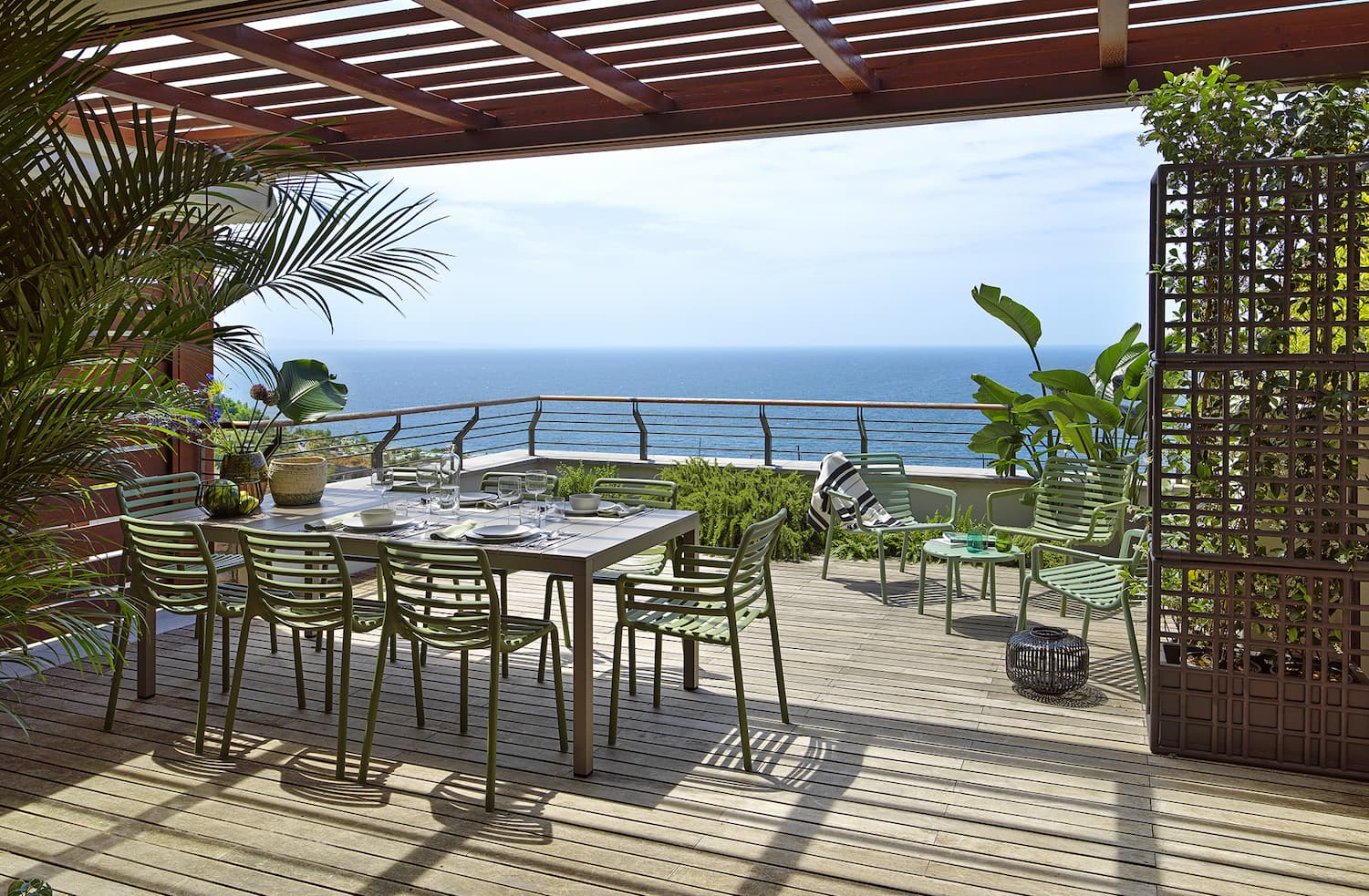 Couple enjoying outdoor dining furniture on a coastal terrace