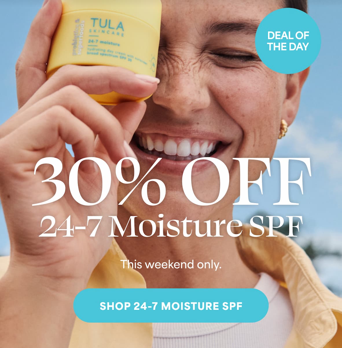 an image of a woman holding a bottle of sunscreen cream