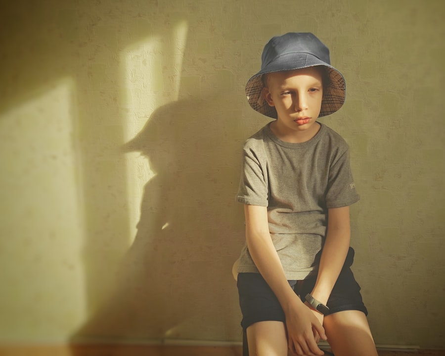 A young boy sitting on a wooden floor