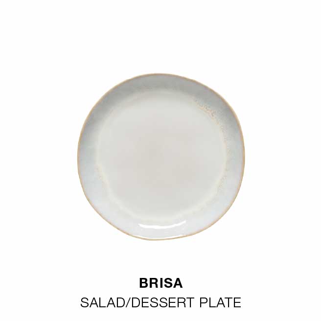Dining room table with Brisa dinnerware in salt white, bowl with glass bottle and dried flowers, and round wooden table set with plates, bowls and Maria linen napkins in white, with text For a cozy meal indoors, followed by salad dessert plate, soup cereal bowl and oval plate in Brisa