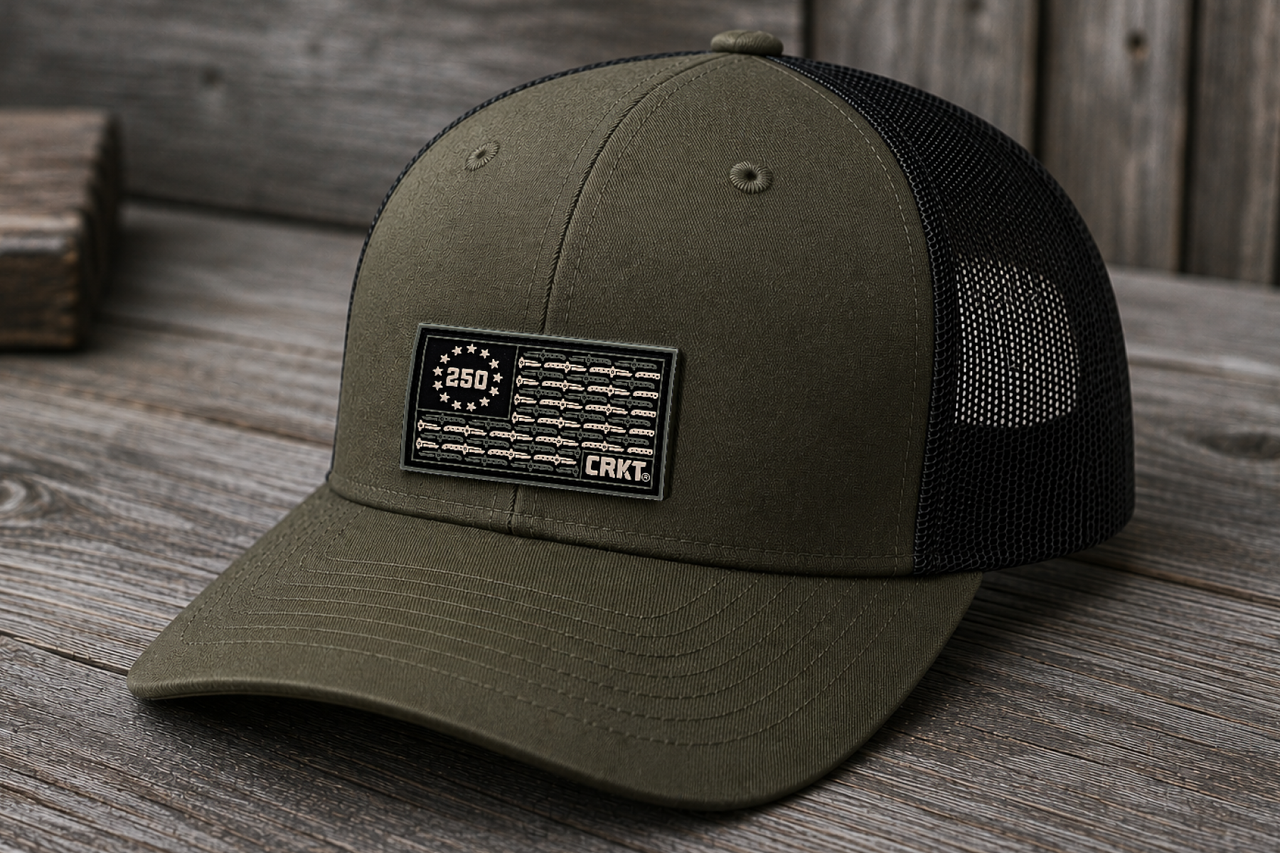 Olive green CRKT trucker hat featuring a USA 250th anniversary patch.