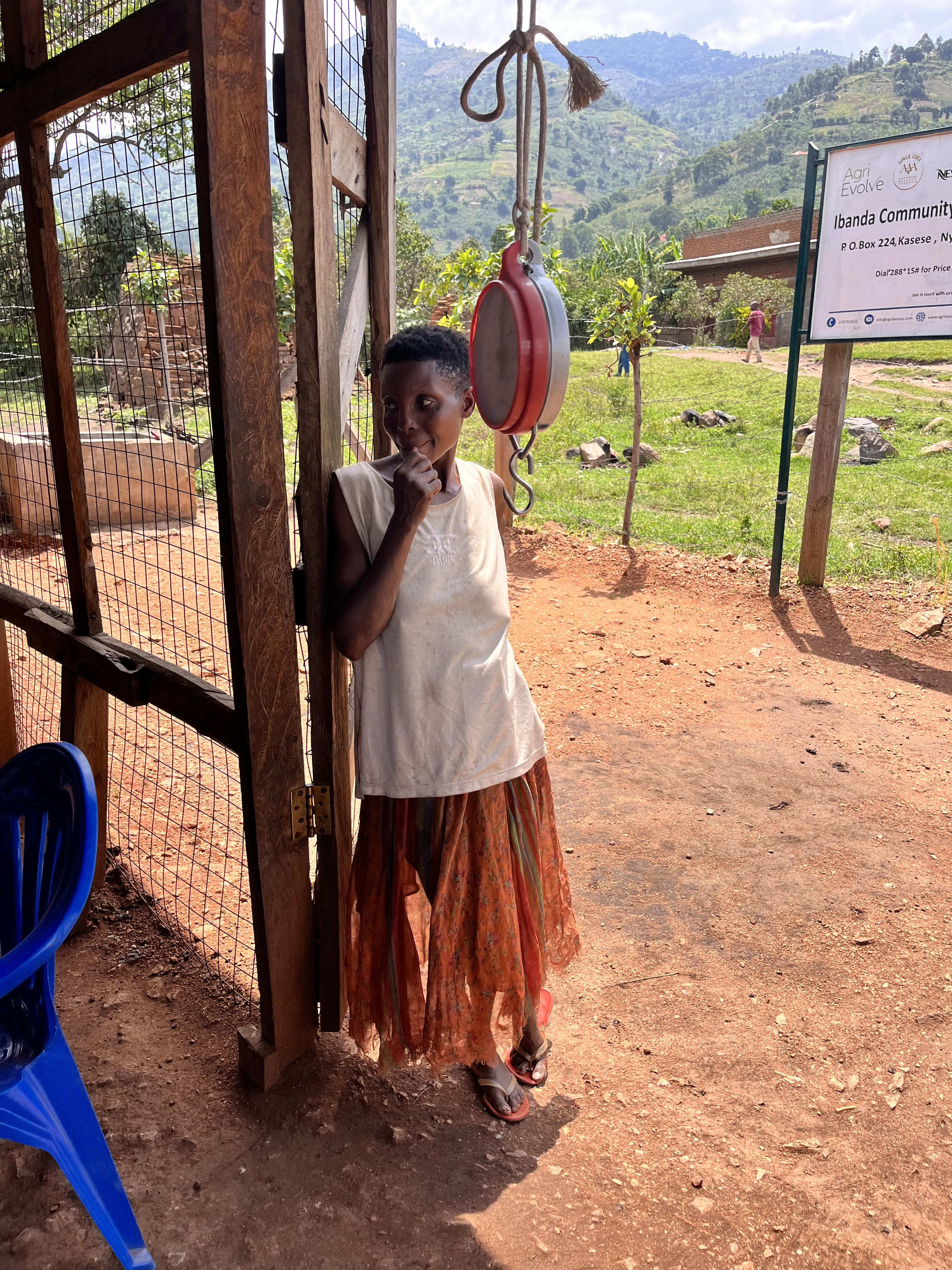 A FEMALE COFFEE FARMER SELLS HER COFFEE AT THE LOCAL COFFEE STORE