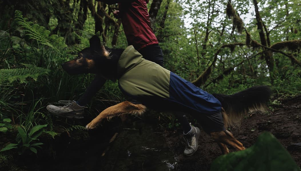 Lennon leaps over a creek in a Sun Shower™ Coverall