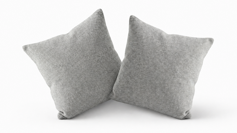 Two grey Eco Cashmere cushion covers, styled with inserts