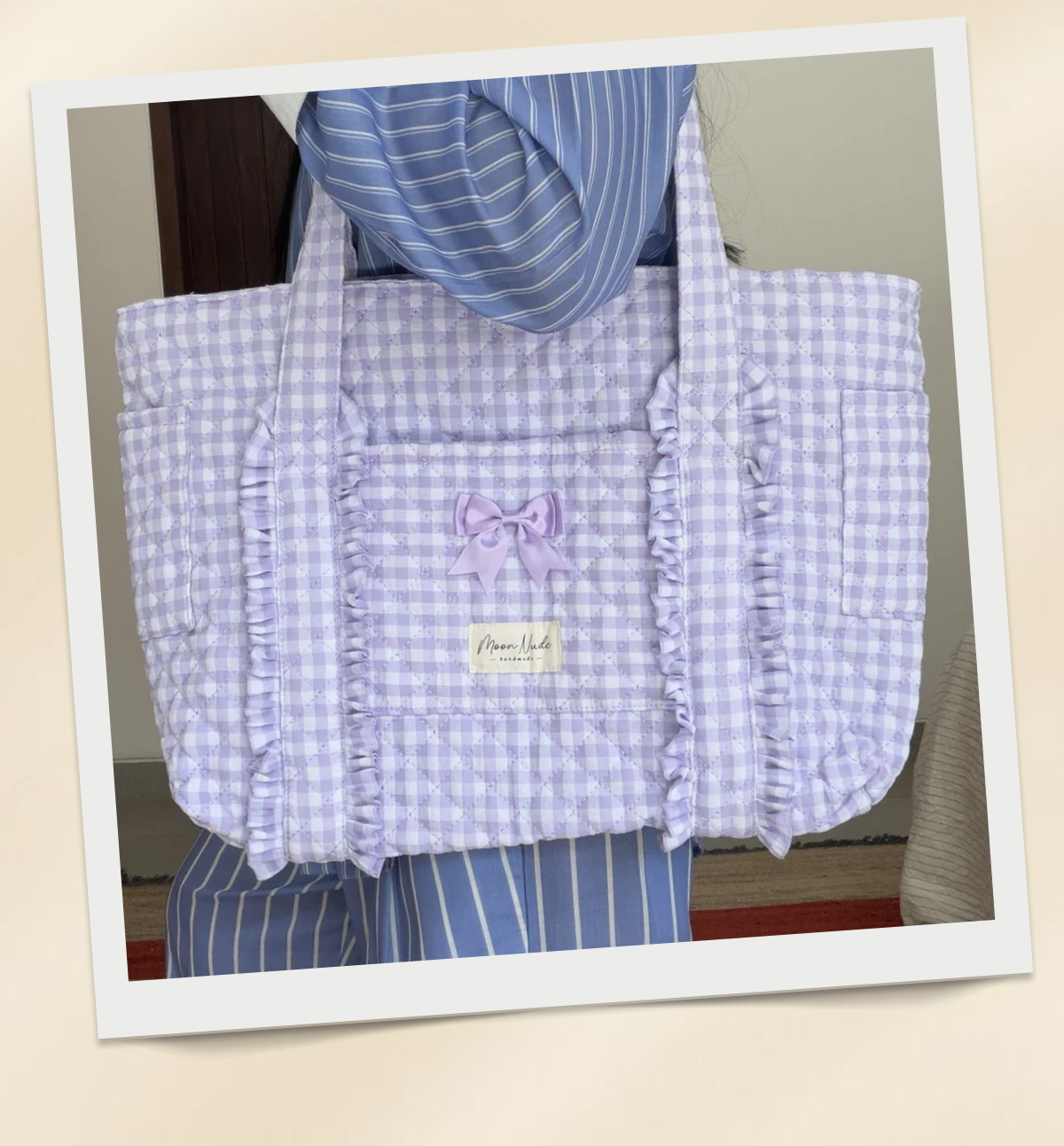 Purple checkered tote bag with ruffles.