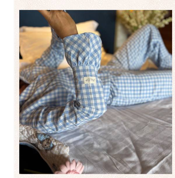 Blue checkered pajamas on a bed.